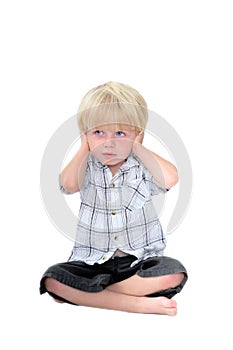 Young boy with his hands over his ears and white background