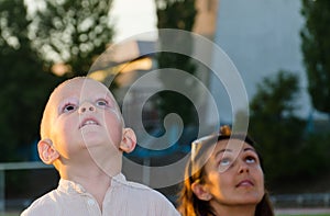 Young boy and his mother looking at