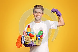 Young Boy Holding Basket of Cleaning Supplies