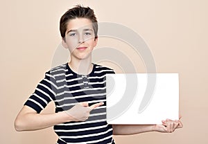 Young boy holding blank white board