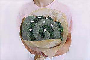 Young boy holding broccoli in hands. Concept healthy food