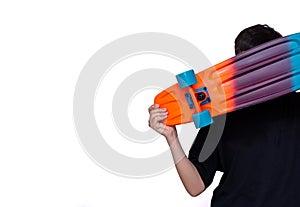 Young boy holding colorful skateboard in hand and white background