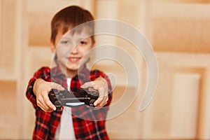 Young boy holding game controller playing video games.