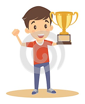 Young boy holding a golden trophy with a happy expression, celebrating a win. Smiling child with award showcases success