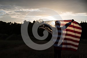 A young boy holding a large American Flag, Independence Day