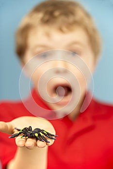 Young Boy Holding Plastic Spider