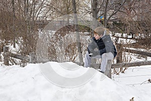 Young boy holding a snowball