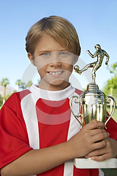 Young Boy Holding Soccer Trophy