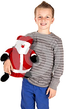 Young boy holding a stuffed santa smiling happily