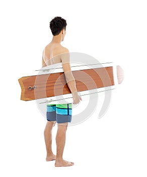 Young boy holding a surfboard over white background