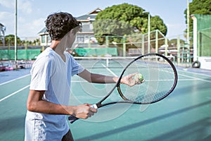 young boy holing tennis racket and playing sport