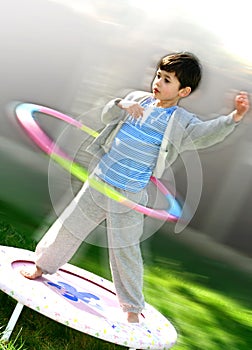 A young boy with a hoola hoop