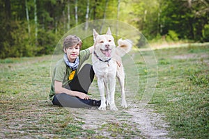 Young boy hugging his dog