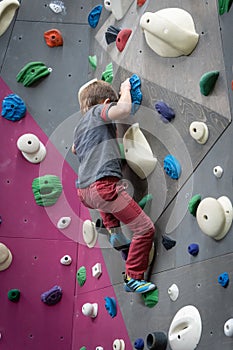 Young boy on an indoor climbing wall