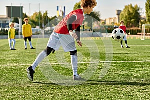 A young boy kicking a soccer