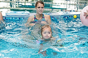 Young boy kid child eight years old splashing in swimming pool having fun leisure activity open arms