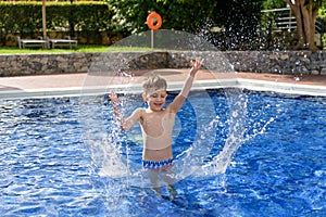 Boy plaiyng in swimming pool