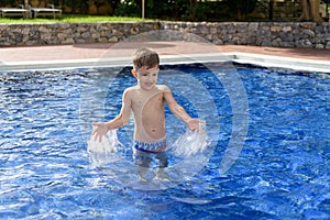 Boy plaiyng in swimming pool