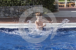 Boy plaiyng in swimming pool