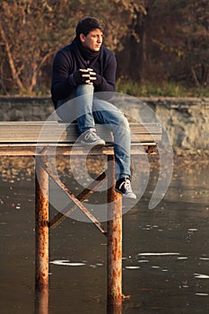 Young boy on a lake pier