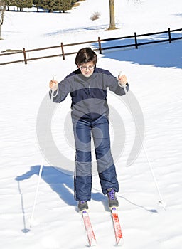 Young boy learns to ski cross-country on skis