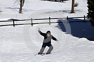 Young boy learns to ski in the mountains in winter