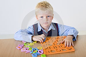 Young boy with letters jigsaw