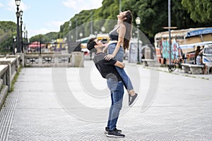 Young boy lifting his happy girlfriend