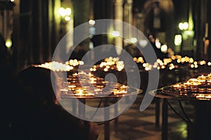 Young boy lighting candles in church