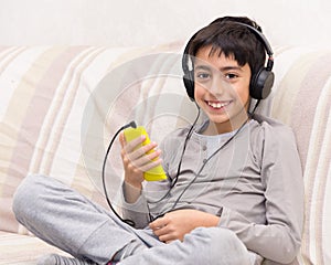 Young boy listening music headphone