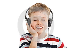 Young boy listening a music in a headphones isolated