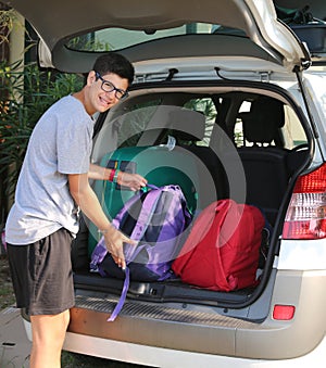 Young boy loads the car