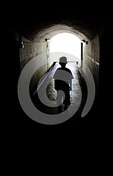 Young boy in long tunnel walkway