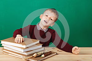 Young boy looking angry shaking his fists tired of school lesson