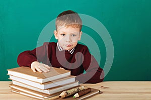 Young boy looking angry shaking his fists tired of school lesson