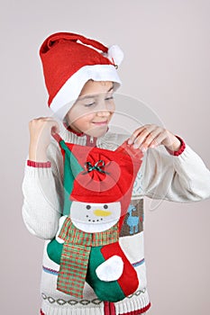 Young boy looking at Christmas present