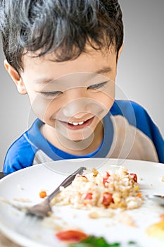 Young boy looking at food excitedly at home