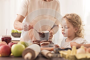 Young boy looking at muffins