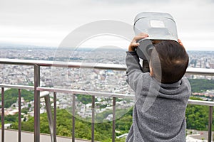 Young boy looking through the telescope