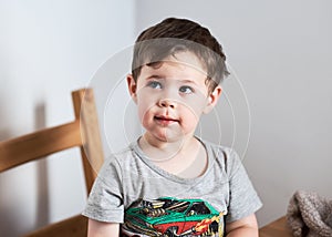 young boy making faces at the kitchen table