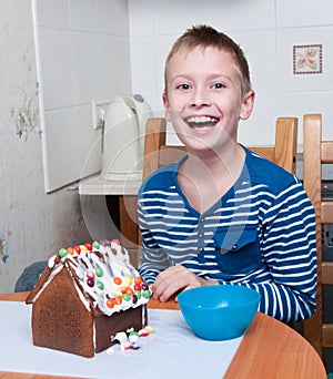 Young boy making gingerbread house