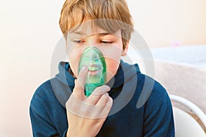 Young boy making inhalation with nebuliser in exam photo