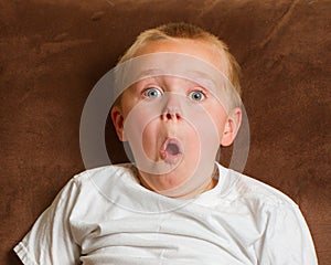 Young boy making a surprised facial expression