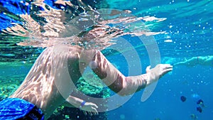 Young Boy with Mask and Tube First Time Snorkeling in Red Sea near Coral Reef