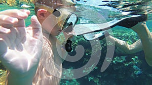 Young Boy with Mask and Tube First Time Snorkeling in Red Sea near Coral Reef