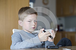 Young boy measure glucose level