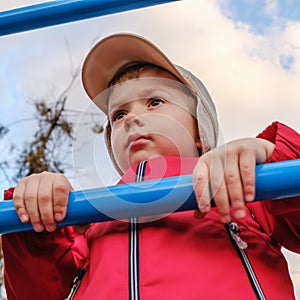 Young boy on metal playstructure