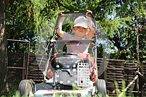 Young boy mowing grass
