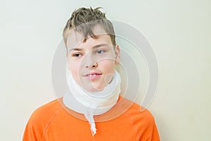 Young boy with neck brace, used for pain in neck,