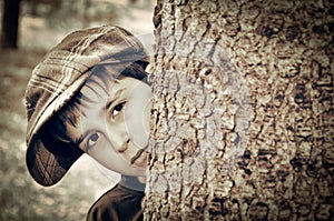 Young boy with newsboy cap playing detective